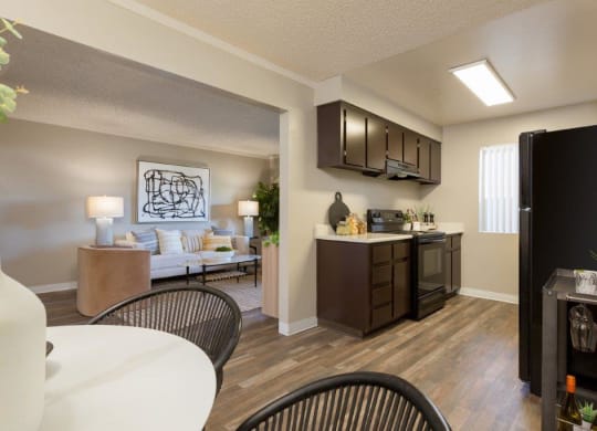 a kitchen and living room with a table and chairs