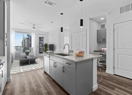an open kitchen with a large island and a living room
