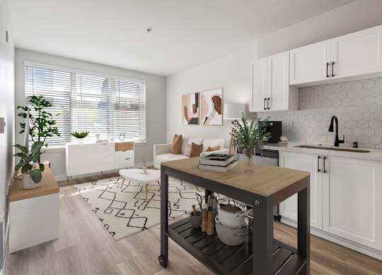 A kitchen with white cabinets and a wooden island.