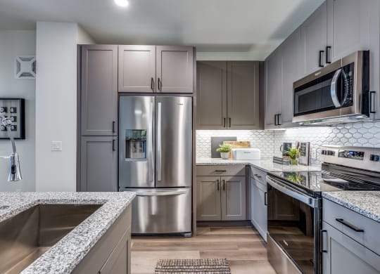 an open kitchen with granite counter tops and stainless steel appliances