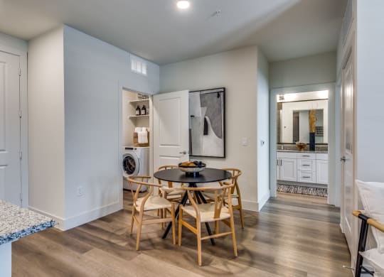 a dining room with a table and chairs and a laundry room
