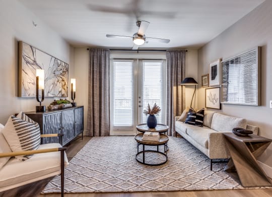 a living room with a couch and a door to a balcony