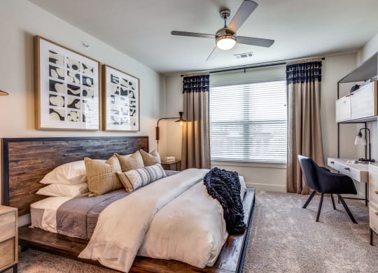 a bedroom with a large bed and a ceiling fan