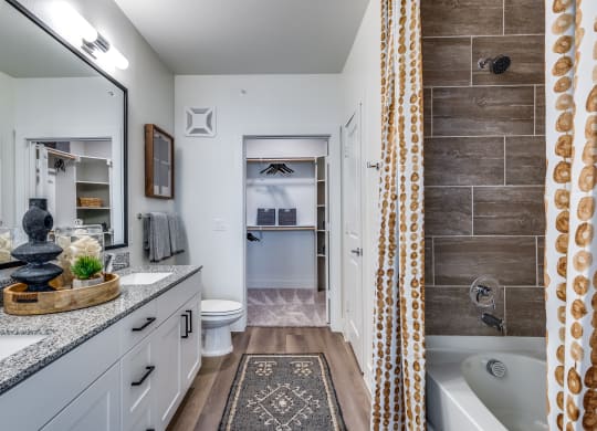 a bathroom with a tub and a shower and a sink