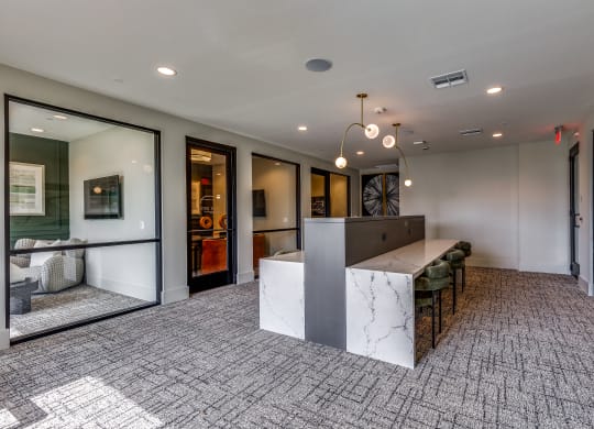 a large lobby with a reception desk and a table with chairs