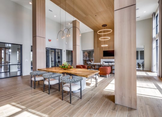 a large dining room with a wooden table and chairs