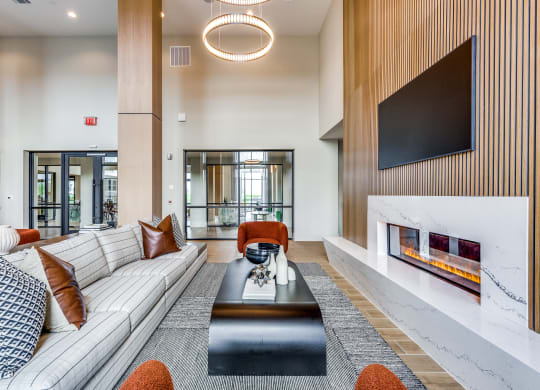 a living room with a white couch and a coffee table and a fireplace