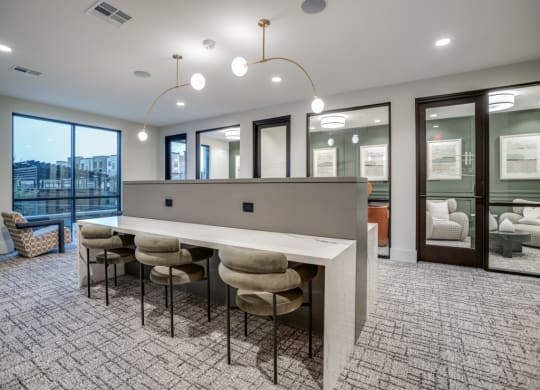 a bar area in a lobby with chairs and a counter