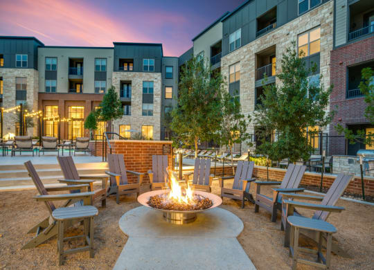 an outdoor patio with a fire pit at an apartment complex