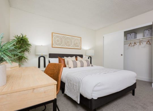 a bedroom with a bed and a table
