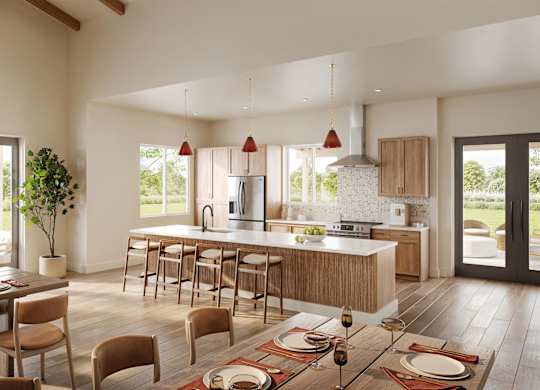 A modern kitchen with a dining table set for a meal.