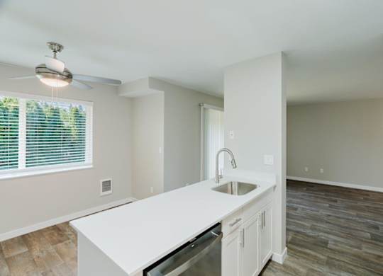 A kitchen with a white countertop and a refrigerator.