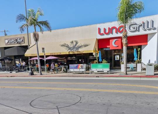 A street view of a Lunch Grill restaurant with a Peet's Coffee shop next to it.