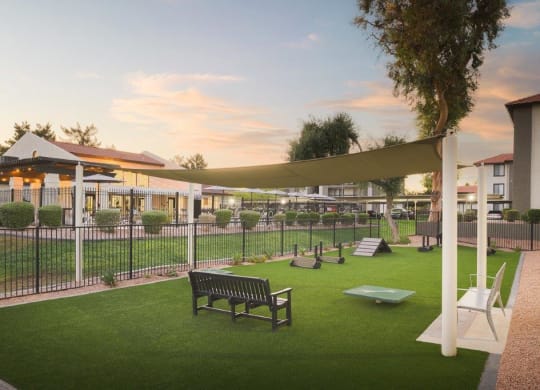 a garden with a bench and a fence