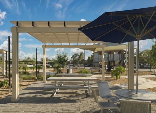 a picnic area with tables and umbrellas