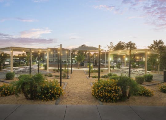 a park with glass pavilions in the evening