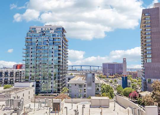 A cityscape with a large building under construction in the foreground.