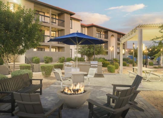 a patio with chairs and a fire pit