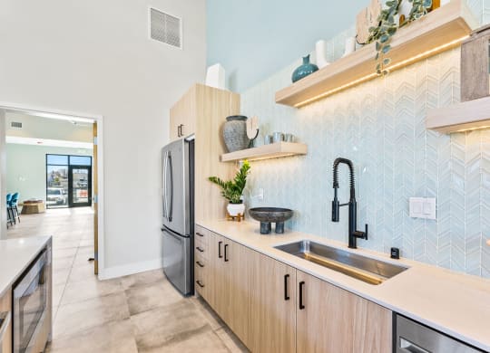 a kitchen with wooden cabinets and a sink and a refrigerator