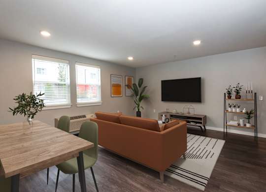 A living room with a brown couch, a wooden table, and a television.