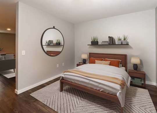 A bedroom with a large bed and a mirror on the wall.