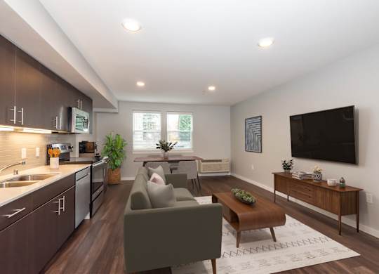 A modern living room with a grey couch and a wooden coffee table.