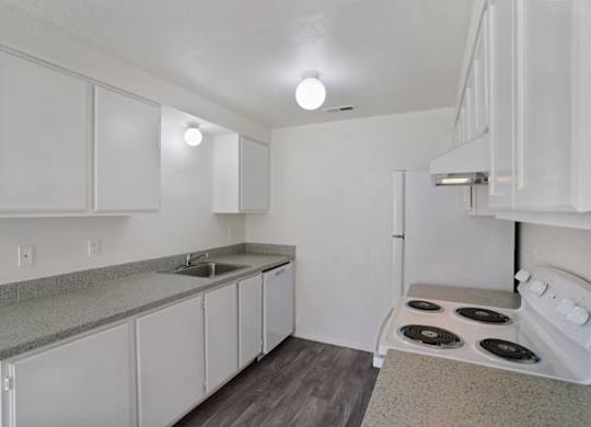 A kitchen with white cabinets and a stove top oven.