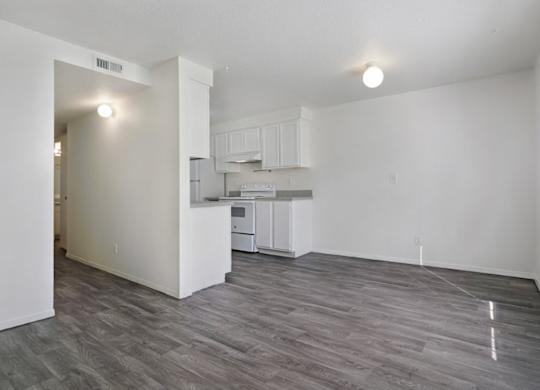 A kitchen area with a refrigerator, microwave, and oven.