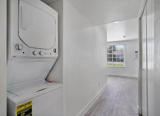 A white fridge in a room with a white wall.