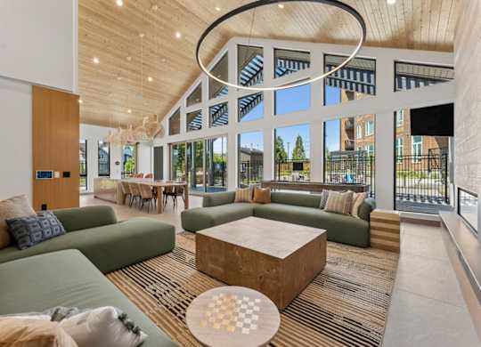 A modern living room with a green sofa and a wooden coffee table.