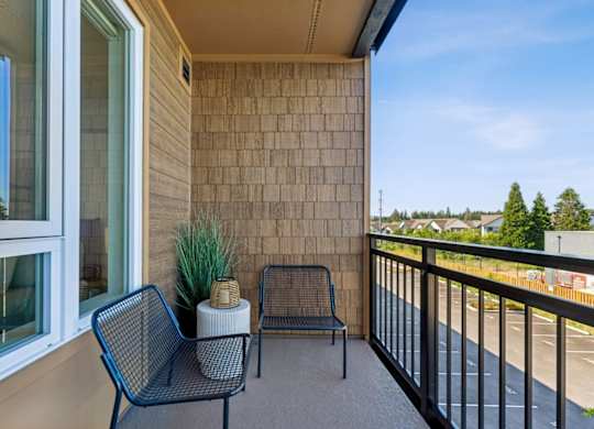 A balcony with a chair and a table.
