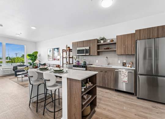 A modern kitchen with a dining table and chairs.