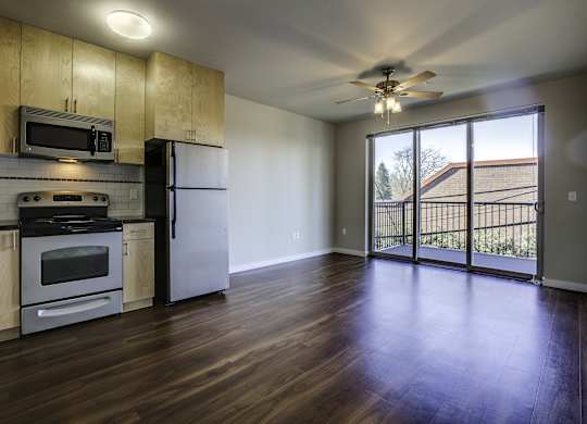 A kitchen with wooden cabinets and a refrigerator.
