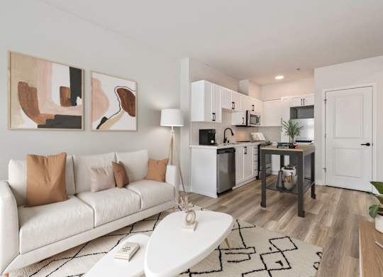 A modern living room with a white couch and a coffee table.