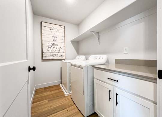 A laundry room with a washer and dryer.