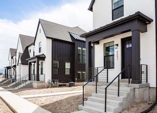 A row of modern houses with black and white exteriors.