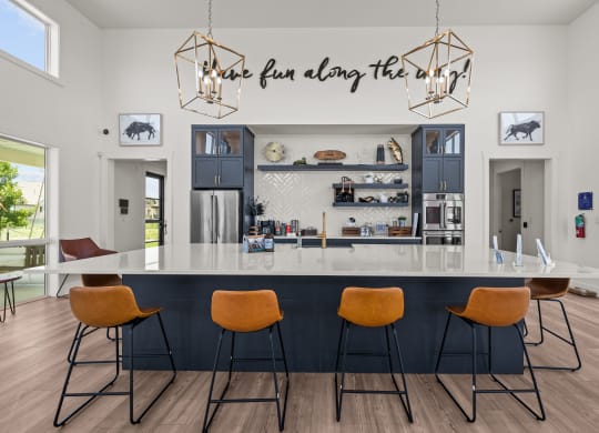 a kitchen with a counter top and four chairs