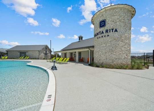 a swimming pool with a building and a water tower