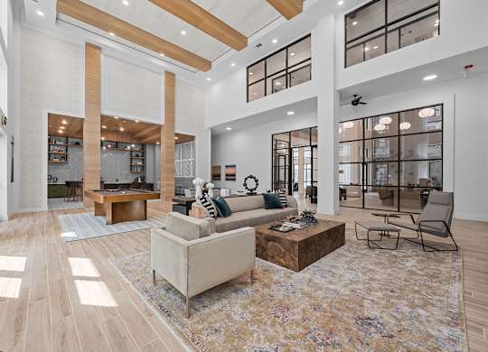 A spacious living room with a large rug and a sofa.