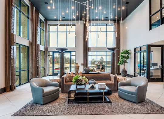 A modern living room with a large window and a rug on the floor.