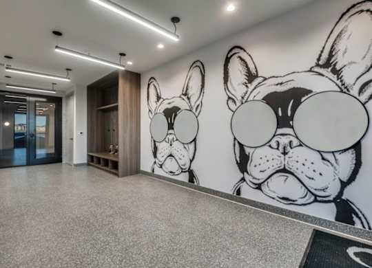 A hallway with a large mural of a dog's face on the wall.