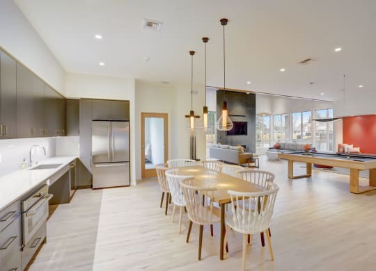 a kitchen and dining room with a table and chairs