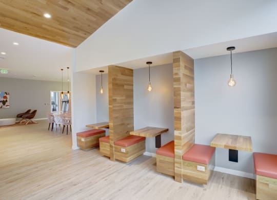 a seating area with benches and tables in a room