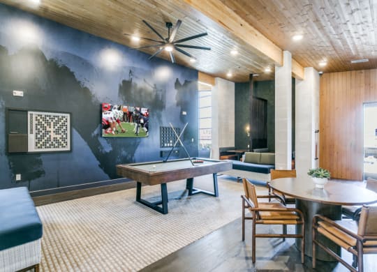 a game room with a ping pong table and a painting on the wall