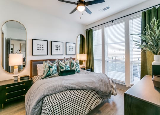a bedroom with a large bed and a ceiling fan