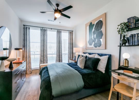 a bedroom with a large bed and a ceiling fan