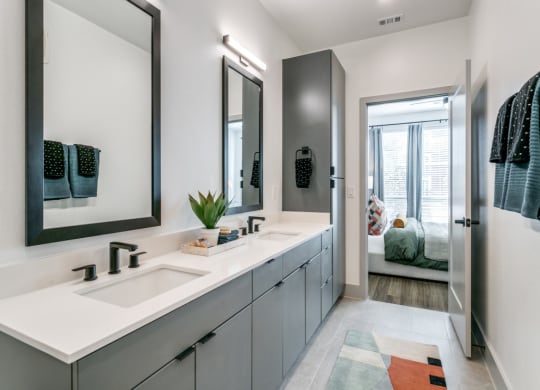 a bathroom with two sinks and a mirror
