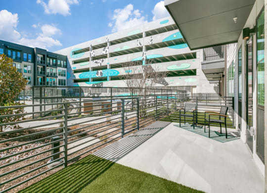 a balcony with a view of a building and a train track