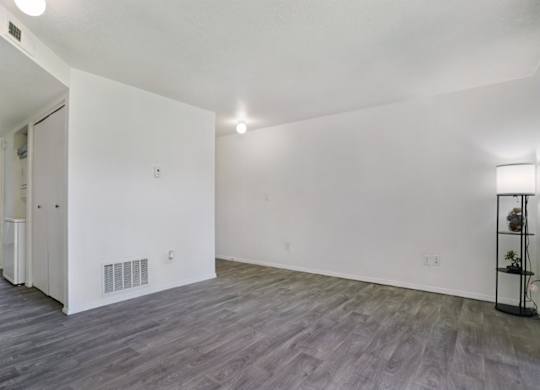 A room with a grey floor and white walls.