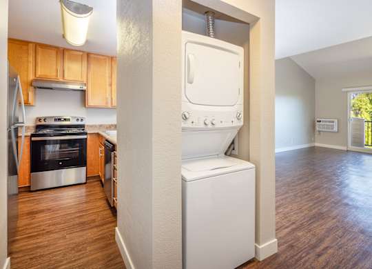 A modern kitchen with wooden cabinets and a white dishwasher.
